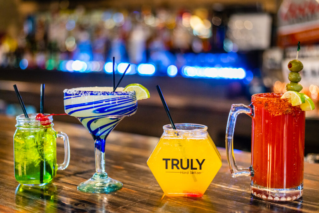 A table with drinks and glasses on it