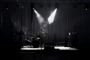 A stage with lights and a drum set.